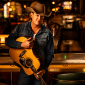 Musician Jon Pardi holding a guitar